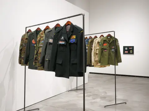 "An Abridged Sonic History of Global Conflict" - installation view, Judith and Norman Alix Art Gallery - Embroidery on army surplus and cashmere wool, steel pipe